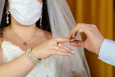 Midsection of couple holding hands