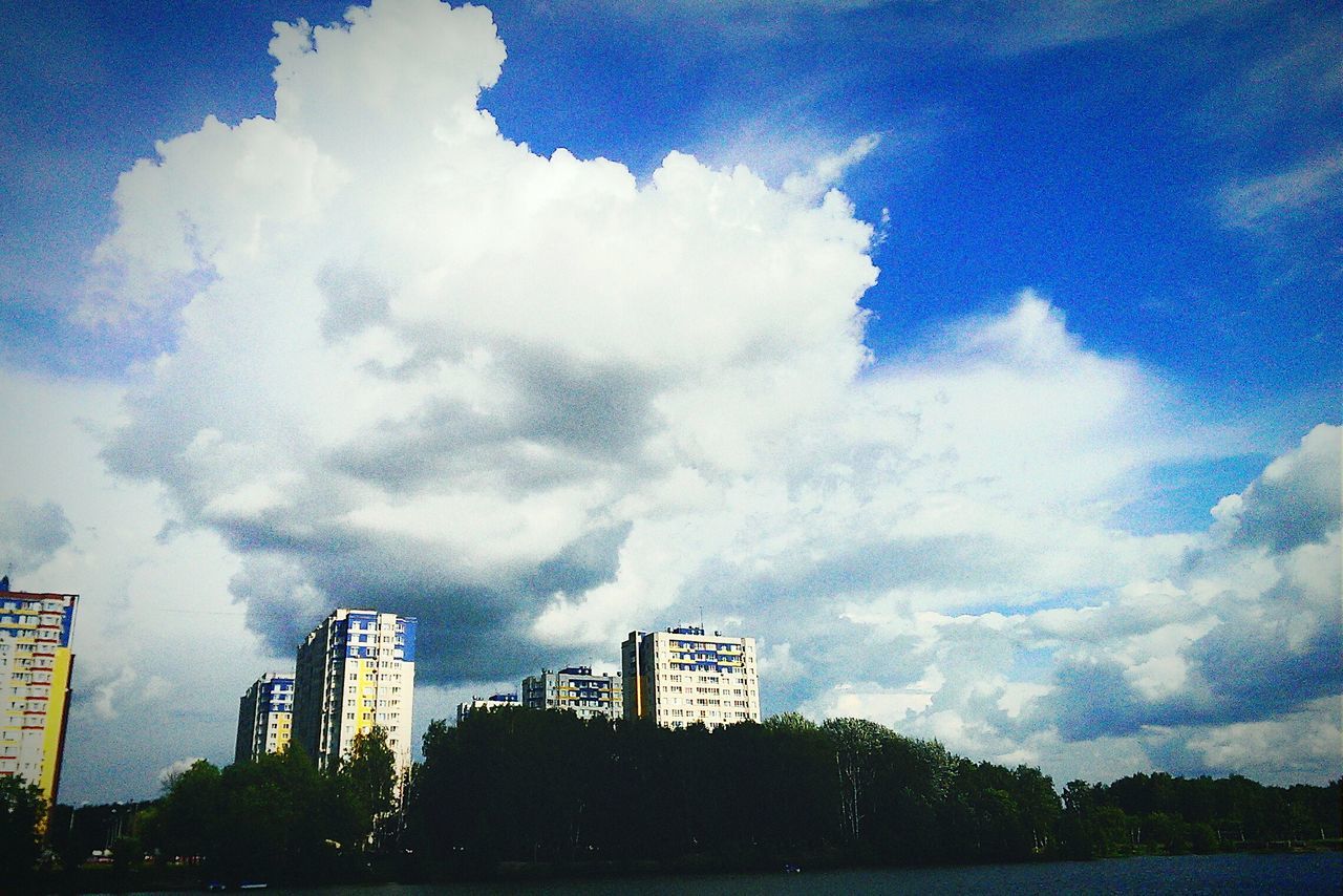 sky, building exterior, architecture, built structure, cloud - sky, cloudy, city, water, cloud, blue, low angle view, weather, building, nature, outdoors, dusk, day, no people, waterfront, sea