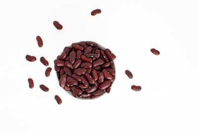 High angle view of coffee beans against white background