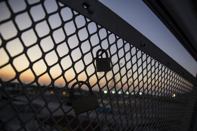 Close-up of chainlink fence against sky