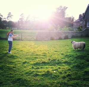 People walking on grassy field