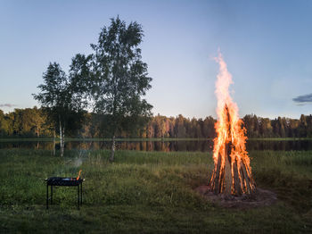 Bonfire on field against sky