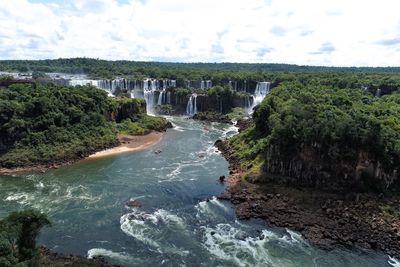 Scenic view of waterfall against sky