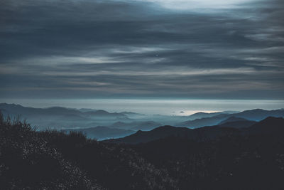 Scenic view of silhouette mountains against sky