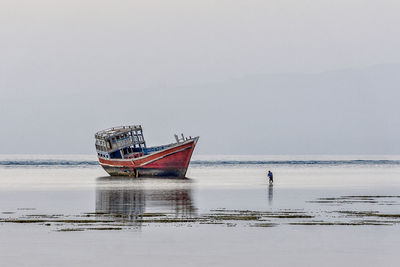 Boat in sea against clear sky