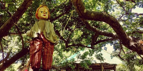 Low angle view of statue against trees