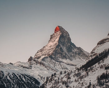 Scenic view of snowcapped mountains against clear sky