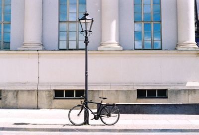 Bicycle against building in city