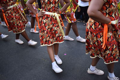 Low section of women standing on street