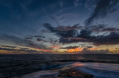 Scenic view of sea against dramatic sky