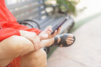 Midsection of man using mobile phone