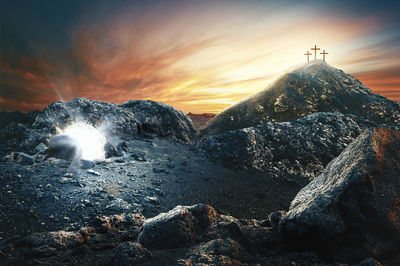 Scenic view of rock against sky during sunset