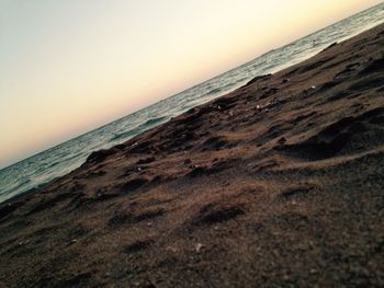 View of calm beach at sunset