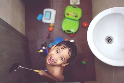 Portrait of cute boy with toy at home