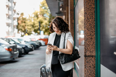 Full length of woman using mobile phone