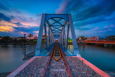 View of bridge over river against cloudy sky