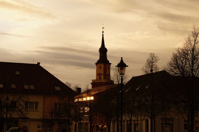 Exterior of houses in town against cloudy sky