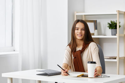 Portrait of young businesswoman working at office