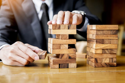 Close-up of man playing stack on wood