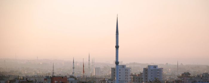 Minarets in city against clear sky