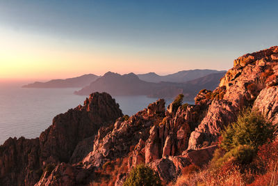 Scenic view of mountains against sky at sunset