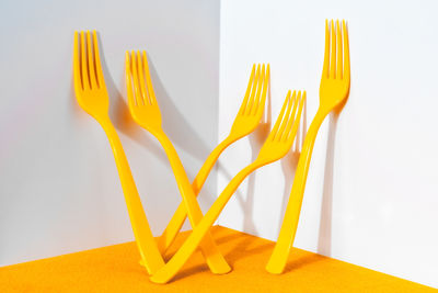 Close-up of yellow served on table against white background