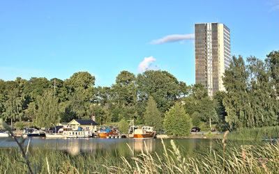 Scenic view of lake by building against sky