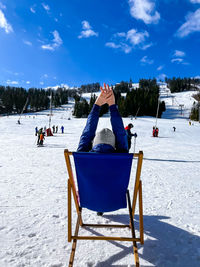 Shot of a skier woman sitting on the ski slope resting relaxing extreme recreation active lifestyle