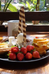 Close-up of strawberries in plate on table