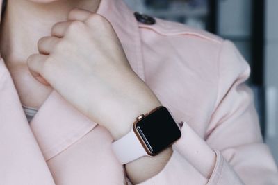 Midsection of businesswoman wearing smart watch