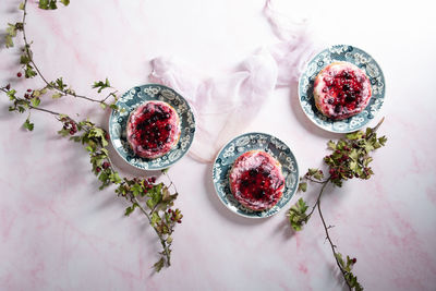 Delicious cake with cream and wild berries, sprinkled with powdered sugar,