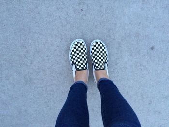 Low section of woman wearing checked pattern shoe