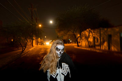 Full length of man on illuminated road at night