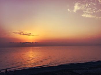 Scenic view of sea against romantic sky at sunset