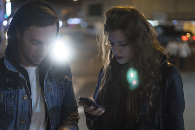 Young woman looking at mobile phone