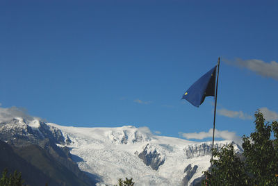 Scenic view of snowcapped mountains against clear blue sky