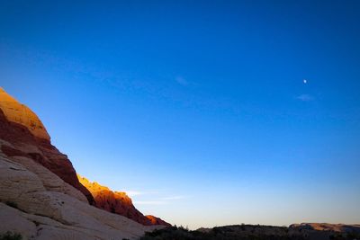 Scenic view of mountains against clear blue sky