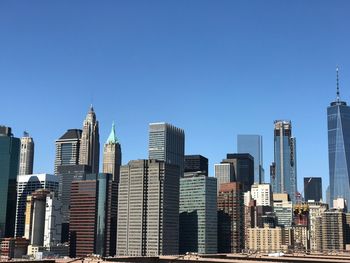 Buildings in city against clear sky