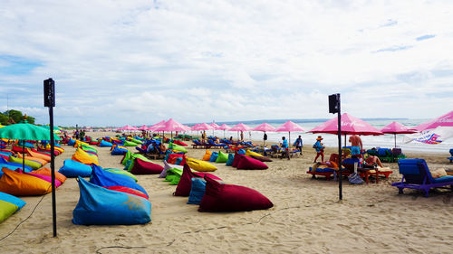 Multi colored umbrellas on beach against sky