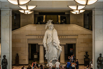 Statue against building in city