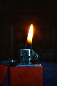 Close-up of lit candles on table
