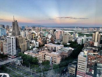 High angle view of buildings in city against sky