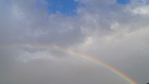 Low angle view of rainbow in sky