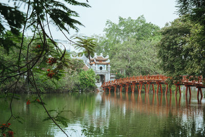 Scenic view of lake by building against sky