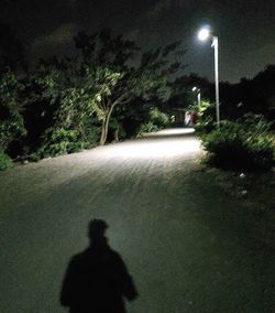 Shadow of people on street at night