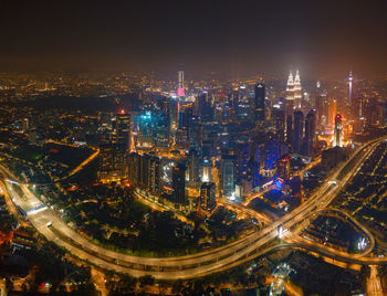 High angle view of city lit up at night