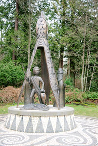 Statue against trees in park