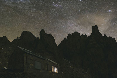 Low angle view of rocks against sky at night