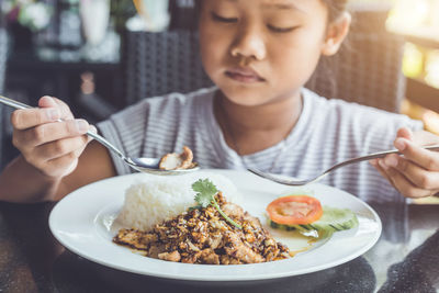 High angle view of man eating food in plate