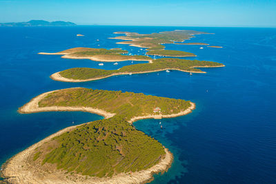 High angle view of island in sea against blue sky